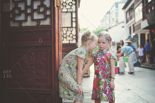 Two little girls in Chinese dresses on a Shanghai street