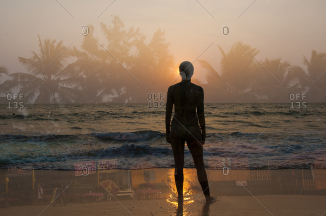 Outline of woman\'s silhouette against tropical scenes