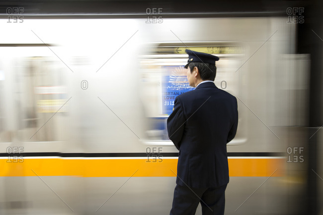Bullet train attendee in Tokyo, Japan