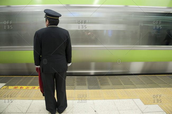 Train attendant in station in Tokyo, Japan