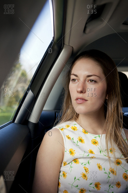 Young woman staring out of a car window