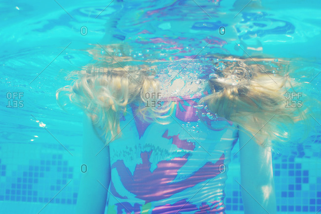 A girl\'s hair floats underwater