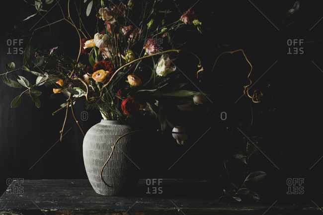 Wild rustic flower arrangement against black background