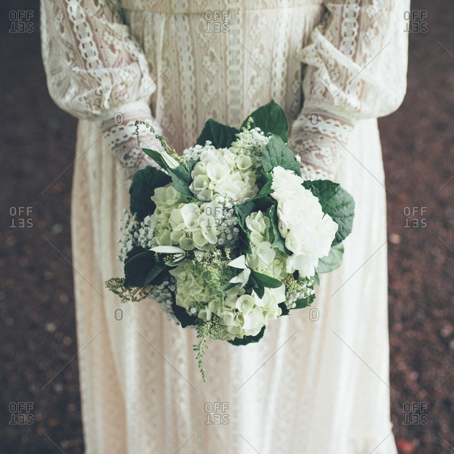 Bride In Old Fashioned Wedding Dress Holding White Bouquet Of