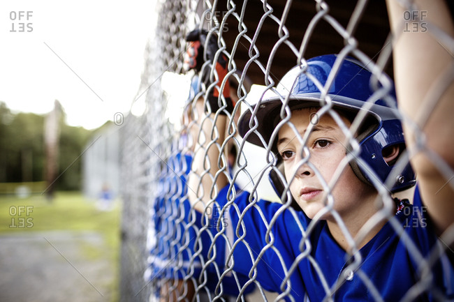 A boy watches his baseball team play