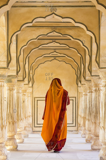 Indian woman walking along a passageway in Amber Fort, Jaipur, Rajasthan, India