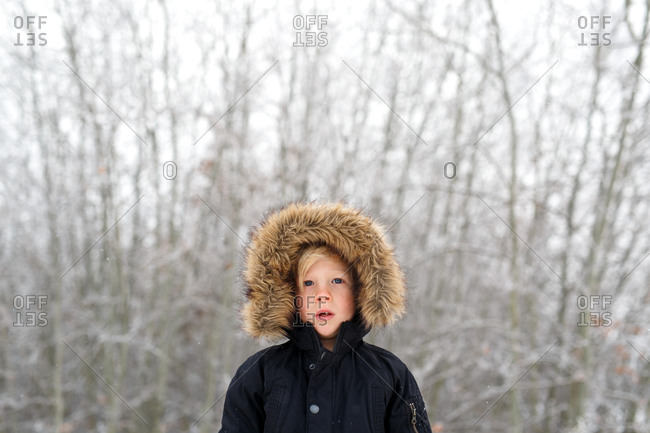 Boy in a fur-trimmed hooded parka outdoors