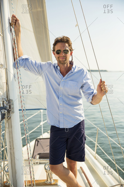 Man leaning on the sails of a private yacht