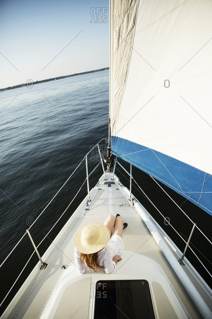 Woman tanning on the deck of a sail boat