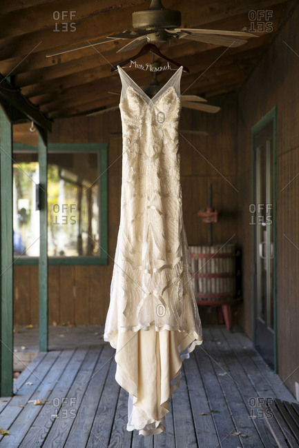 A bride\'s dress hangs from a ceiling fan