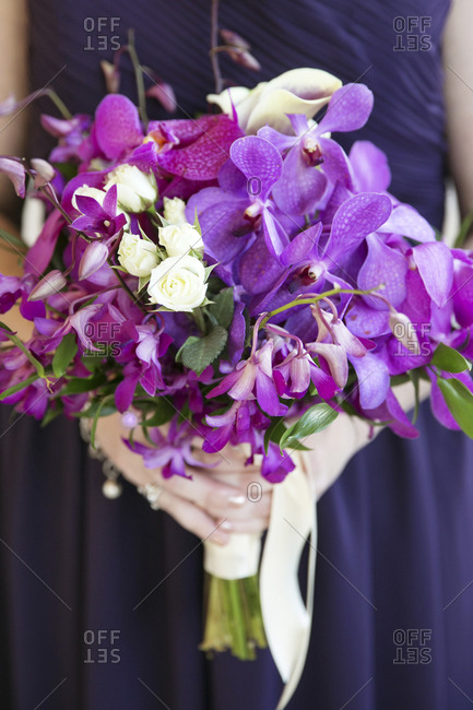 A bridesmaid\'s bouquet of purple flowers