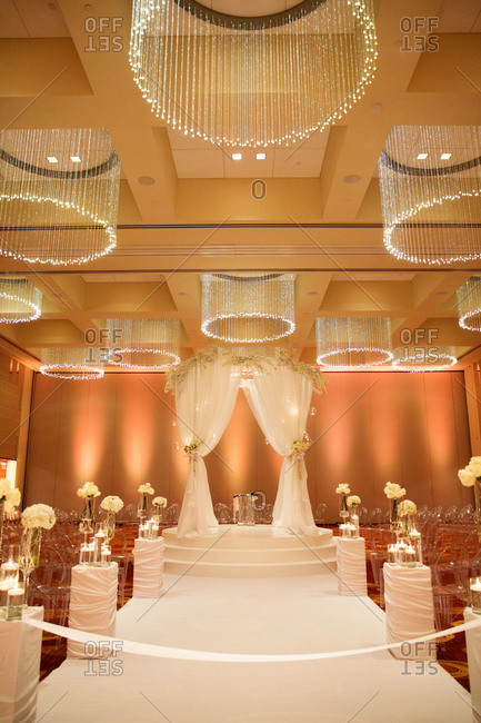 A hotel ballroom decorated for a wedding ceremony