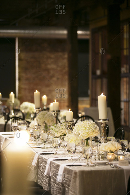 Tables set with pillar candles at a wedding reception