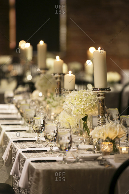 A table set with pillar candles at a wedding reception