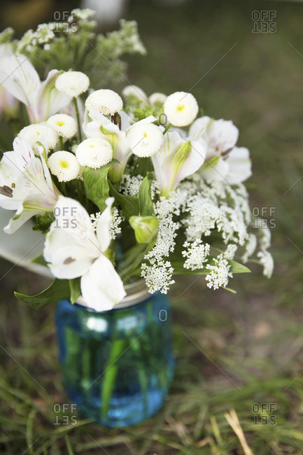 White flowers in a blue mason jar