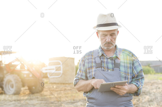 Farmer with digital tablet on field