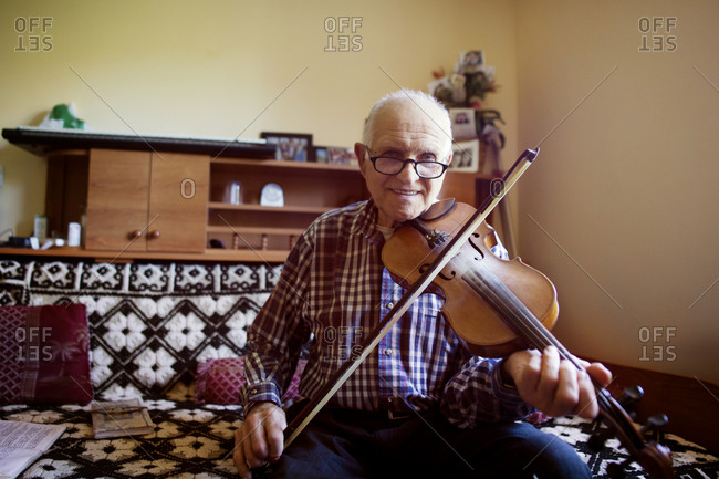 An old man playing a violin