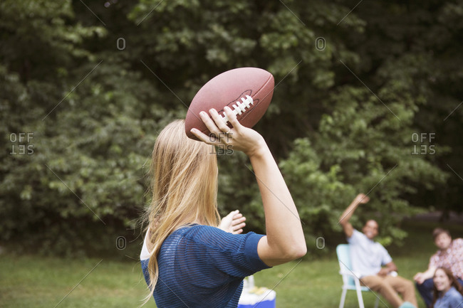 Woman about to throw football to friends
