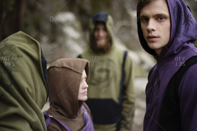 Spiritual young man with friends during hike