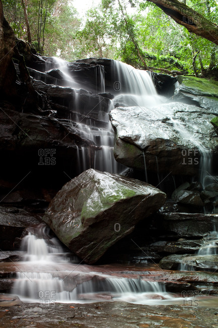 Water cascading down rock falls in the woods