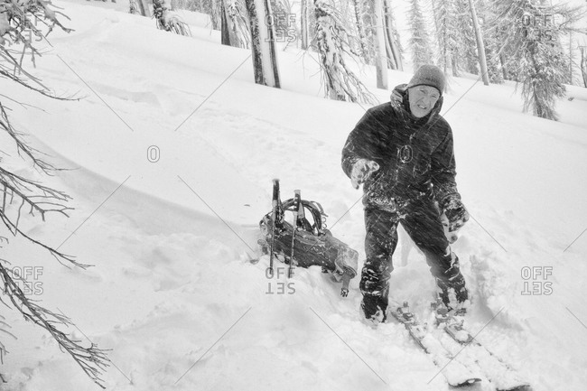 A backcountry skier suffers in blowing wind and cold temperatures during the change over in the Bitterroot Mountains near Victor, Montana