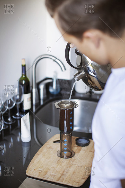 A man brews coffee in a single serving press