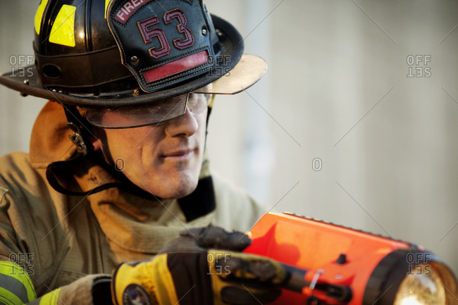 A fireman using a flashlight