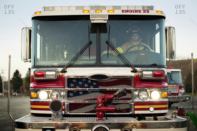 A fireman driving a fire engine