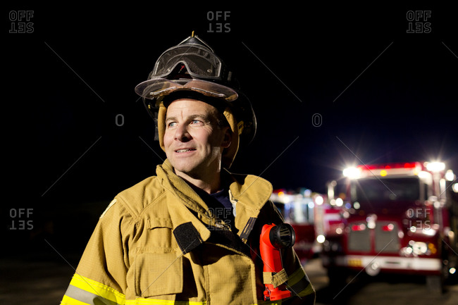 A fireman smiling at night