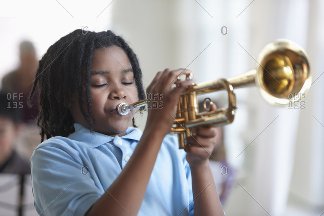 Student playing trumpet in music class
