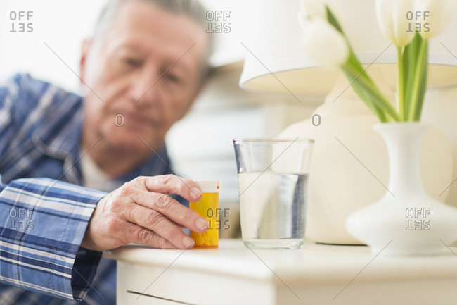 Elderly man taking his medication