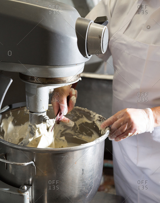 Close-up of a pastry chef working with an industrial mixer