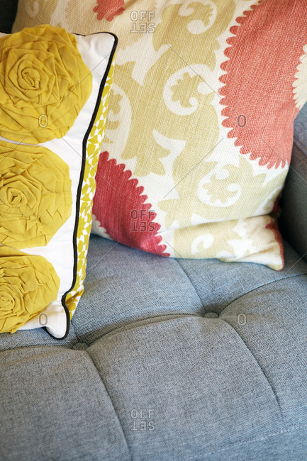 Close-up of throw pillows on a blue upholstered sofa