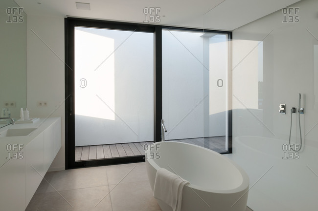 Modern white bathroom with oval bathtub