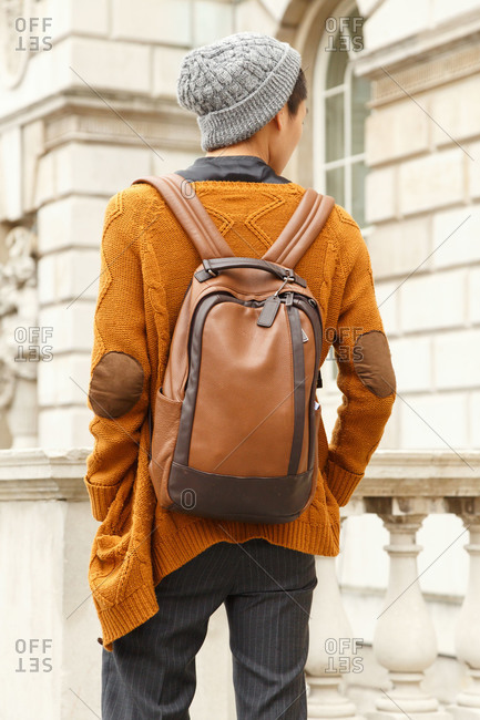Man wearing a brown leather backpack