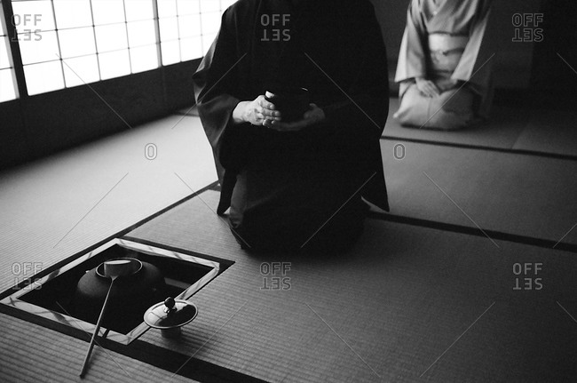 Two people participate in a Japanese tea ceremony