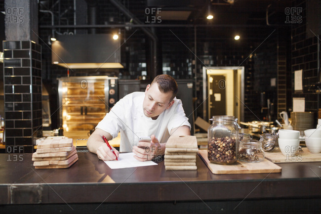 Chef writing a list in a restaurant