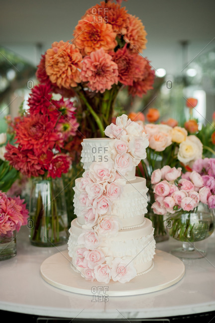 Three-tiered wedding cake with a cascade of pale pink roses