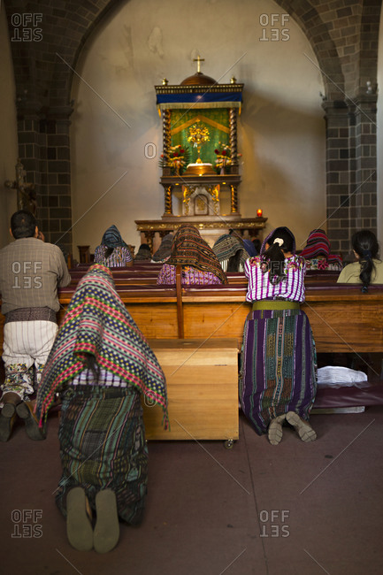 People praying in church in Santiago Atitlan, Guatemala