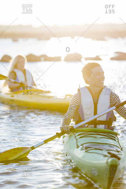 Mother kayaking with daughter following her
