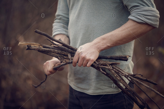 Man collecting sticks for campfire