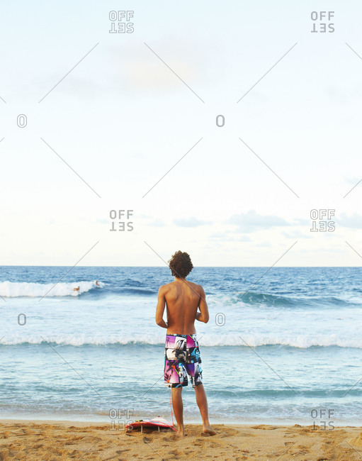 A surfer looks out at the ocean in Puerto Rico