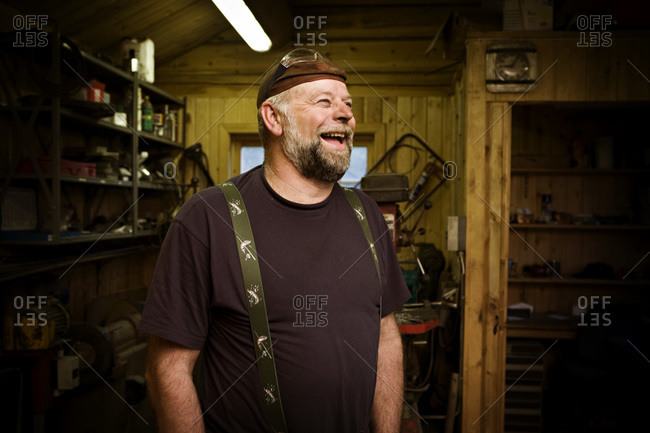 Laughing craftsman in his workshop
