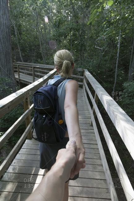 Adult couple holding hands on hike