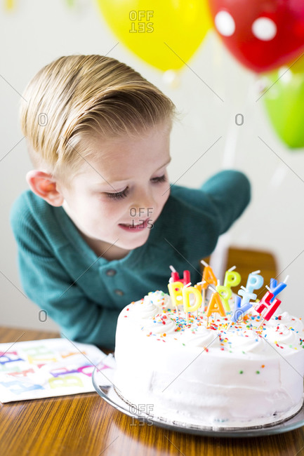 Boy looking at birthday cake