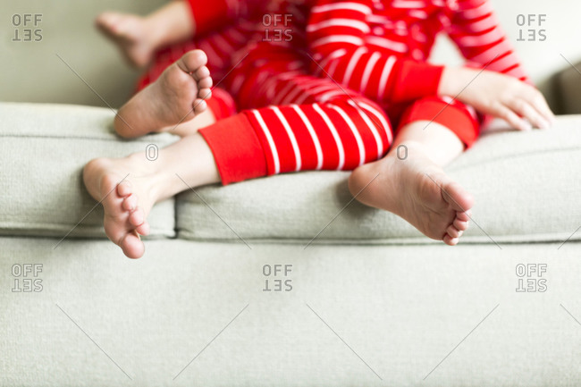 Feet of siblings in red pajamas