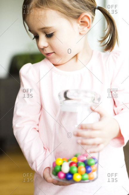 Girl holding glass jar with candies