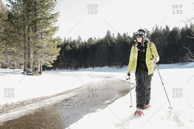 Woman snow shoeing near Donner Lake in California