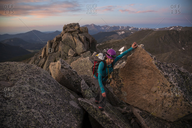 Woman climbing Blitzen Ridge at sunrise, Rocky Mountain National Park