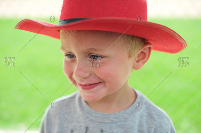 A boy in a red cowboy hat on the Fourth of July